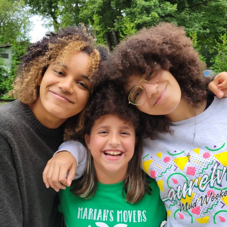 Young girls smile and pose together for a cheerful photo